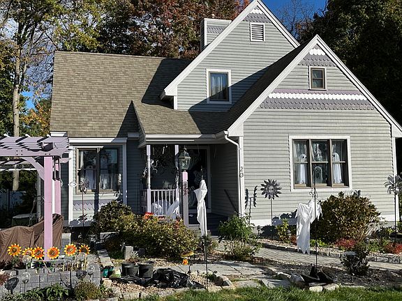 Front of house. Covered front porch. Victorian cape with 1st floor master, living room, foyer, kitchen, formal dining room room, front patio, driveway/kitchen porch and rear 14x16 deck. 1/2 bath and private master bath.