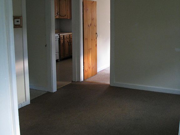 Looking from bathroom towards small bedroom, kitchen and medium bedroom.