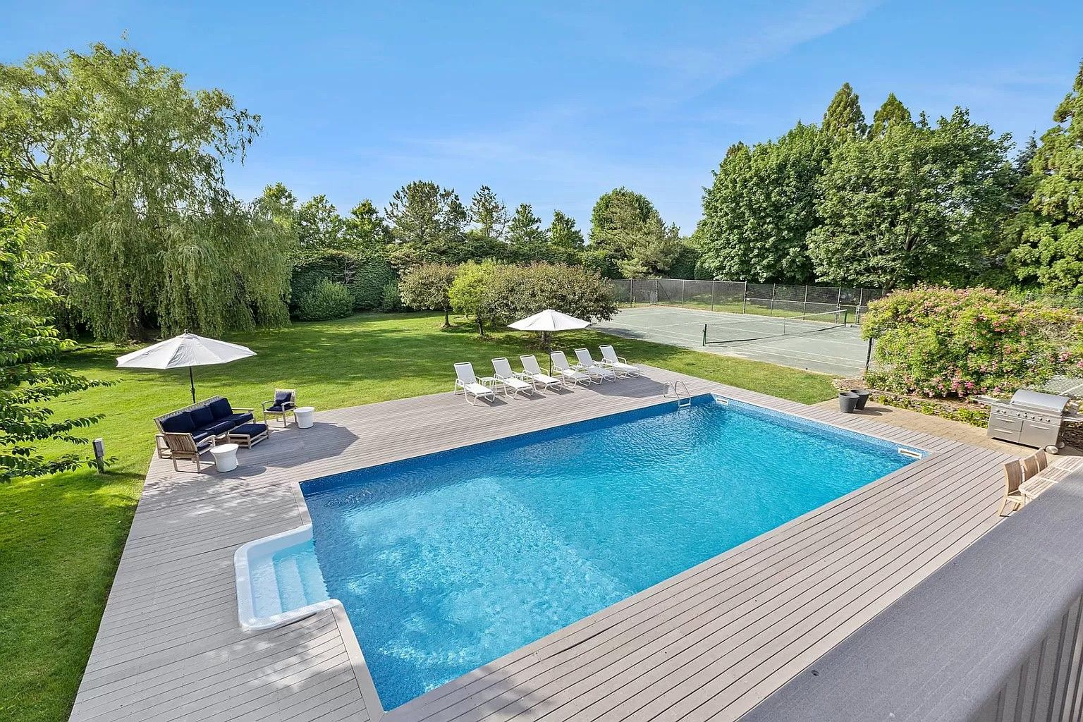  Pool and deck with har-tru tennis court. Deer fenced backyard.