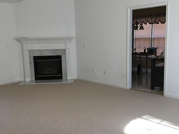 Living room fireplace and doorway to kitchen