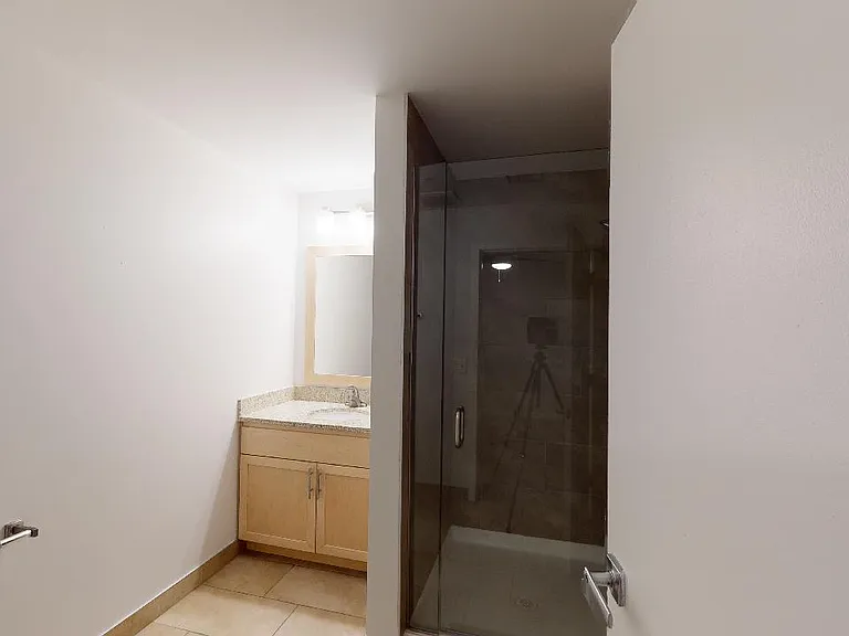 Apartment bathroom with tile flooring.