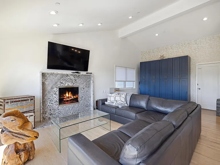 Living, fireplace, pantry area, door to garage