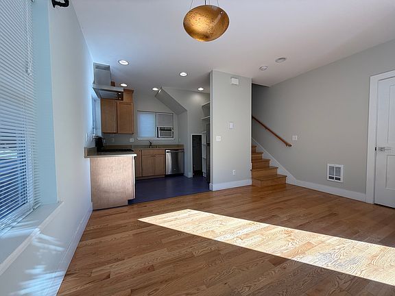Open living & dining area with large windows