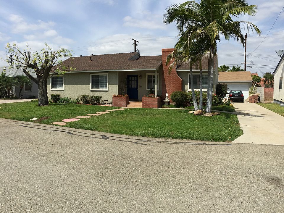 Front of Home with beautiful Palms