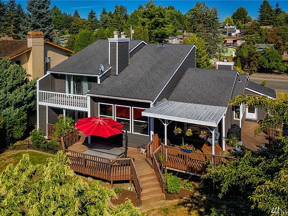 The dining room slider leads to the section of deck that is covered for those rainy NW days. The Master Bedroom slider opens to its own private balcony. Below the master is the 5th bed/Media room, that also has a slider leading out to this massive deck.
