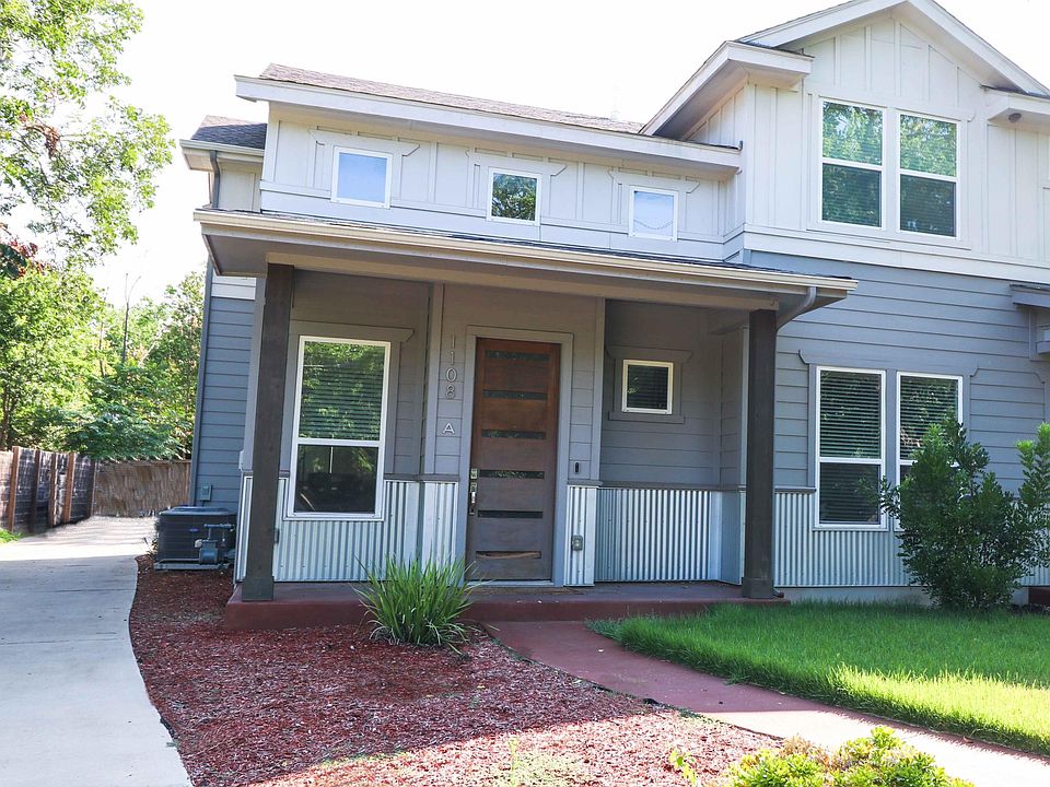 Front view with side driveway (shared) to rear garage