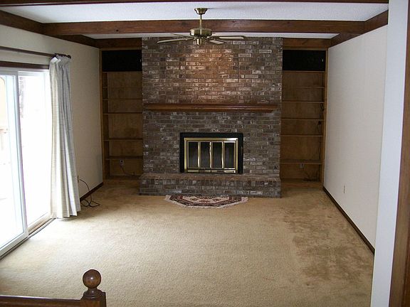 Family Room w/ Fireplace and wall shelves