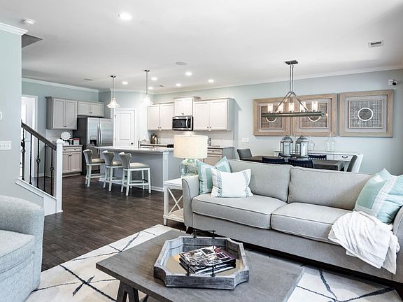 Spacious Gathering Room with hardwood floors perfect for entertaining - Model Representation