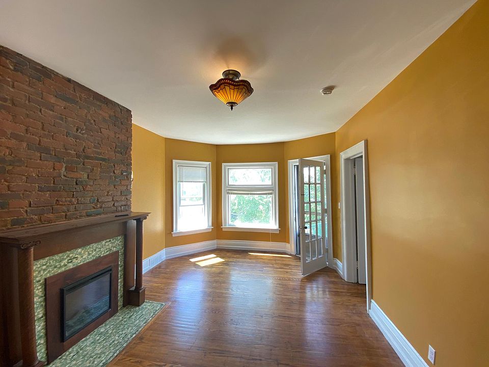 Open floor plan, living room and dining room. Bright and clean with hardwood floors and electric fireplace.