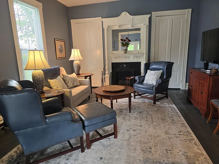 Living area with ample closets. Period mantle; leather chairs and reclining love seat. Pocket door separates living area from Keeping Room/area for privacy. Ceiling fan.