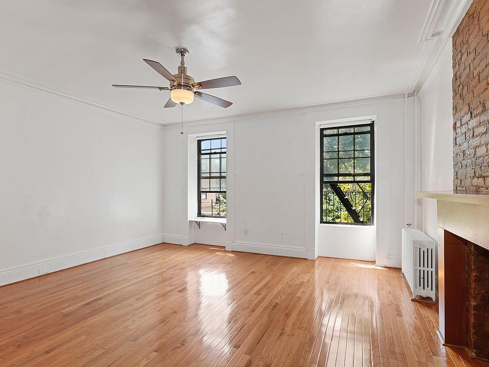 Bedroom with plenty of natural lighting with fire escape balcony.