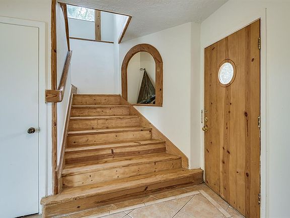 THE EXTERIOR STAIRS LEAD YOU TO THE ENTRY WHICH LEADS YOU TO THE GREAT ROOM, BEDROOMS, STUDY NICHE AND GREAT STORAGE ROOM. THE STAIRWAY FEATURING WOOD TREAD LEADS YOU TO THE LIVING AREA, MASTER SUITE AND 2 OTHER SPARE BEDROOMS.