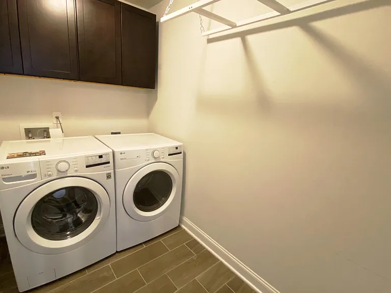 Laundry room with washer/dryer and hanging rack