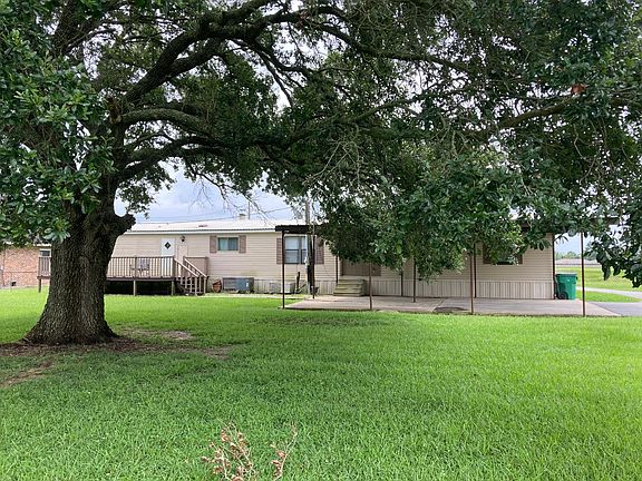 Back yard has large oak tree for shade