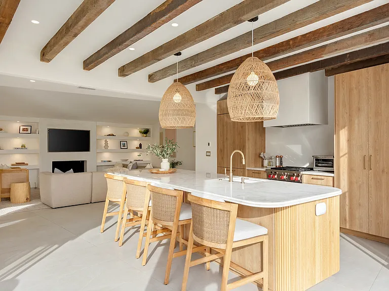 Polished stone countertops and integrated appliances make this kitchen a dream.