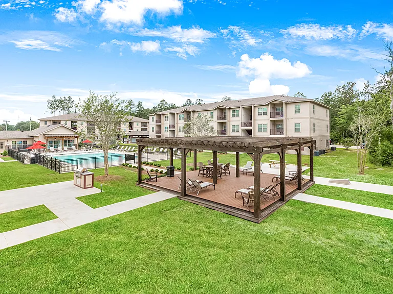 Spacious courtyard with outdoor lounge area, grilling station and pool
