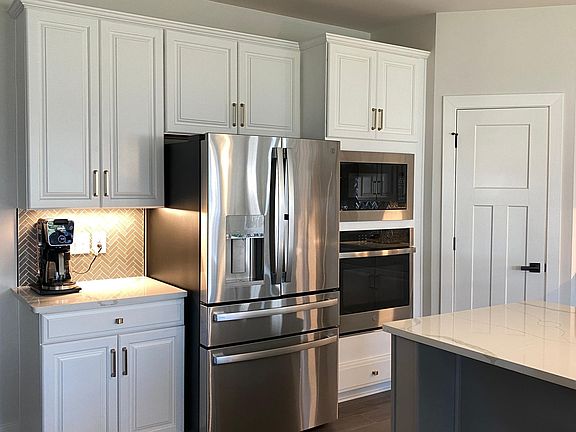 GE refrigerator with 27 Cubic Feet of space, and coffee station.