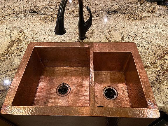 Hammered copper farm sink