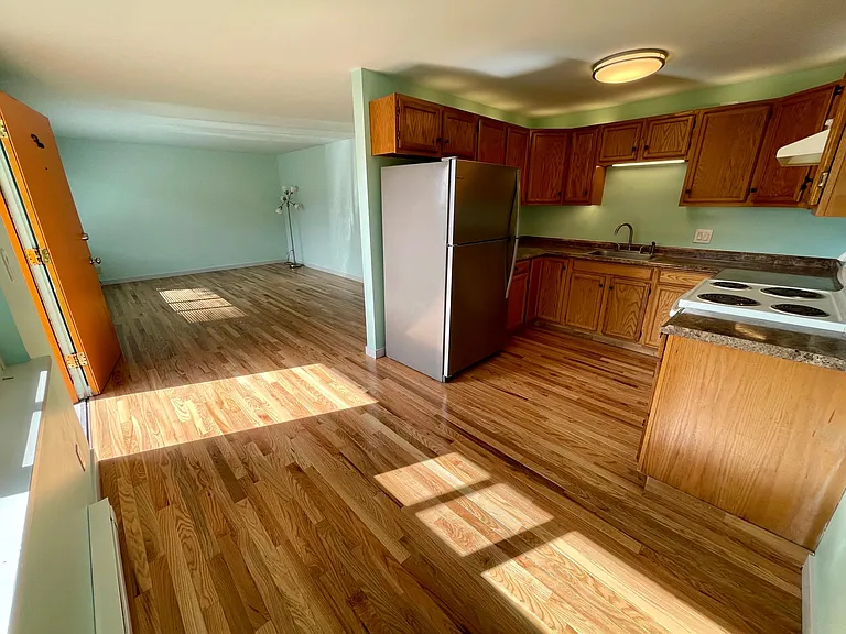 Kitchen and dining with view to living room. (Living room is much more spacious than it appears.)