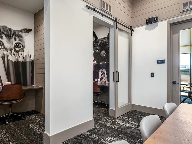 Private Workstations with Built-In Desks and Playful Pet-Themed Artwork