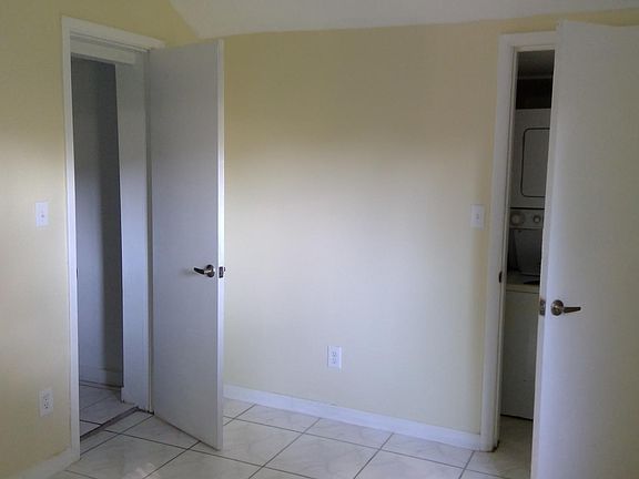 Bedroom showing washer dryer hookup and walk in closet