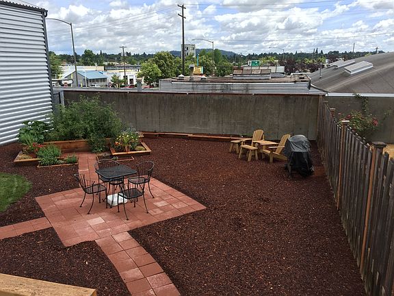Private back yard with common areas and planting beds