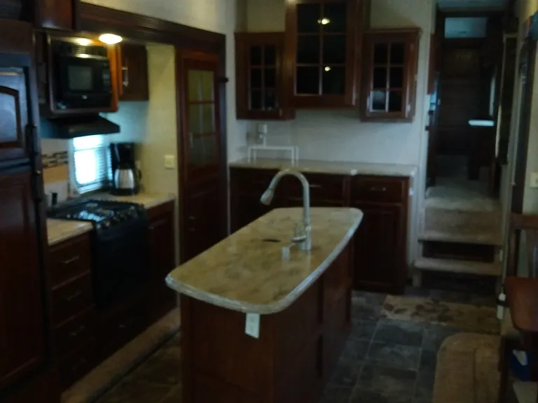 Kitchen island, dining table, steps to bedroom.
