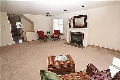 Large living room with gas fireplace. Carpet has been replaced with hardwood floors (including bedrooms).