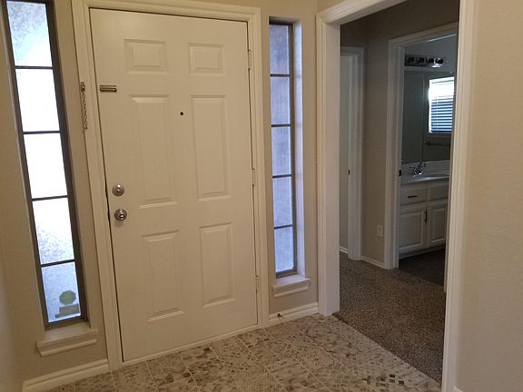 Entry door and hallway to two bedrooms and bathroom.