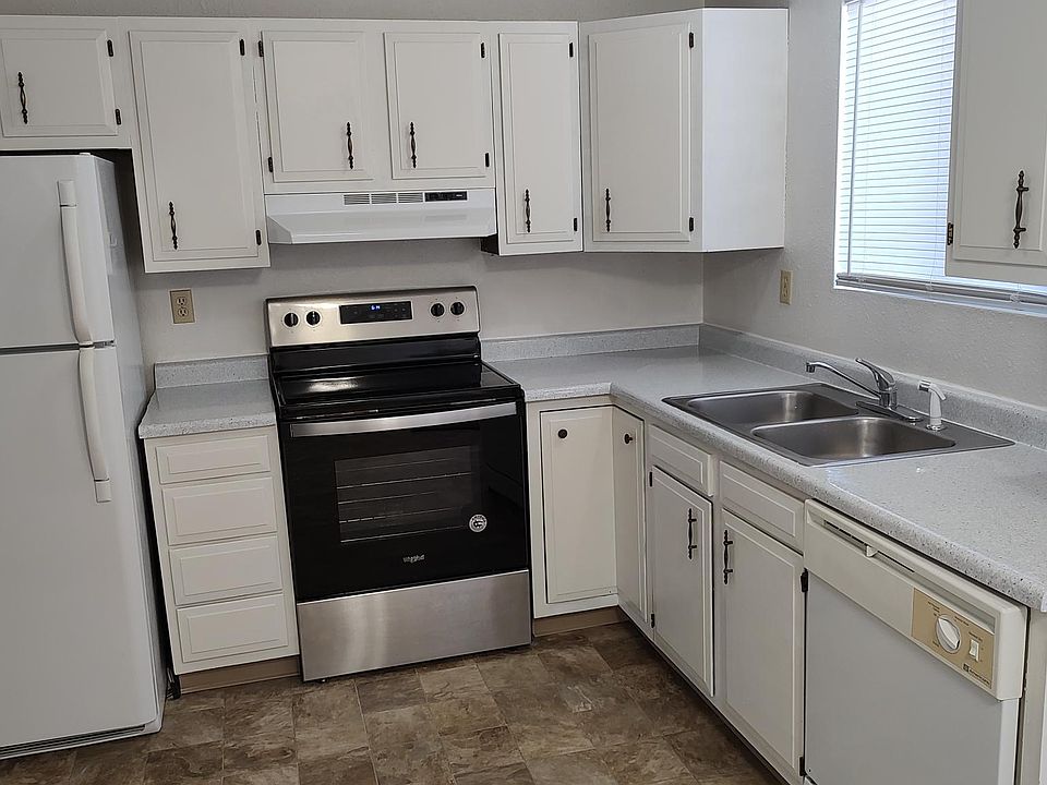 The spacious kitchen has nice appliances including a dishwasher, and a sliding glass door to the patio and rear yard.