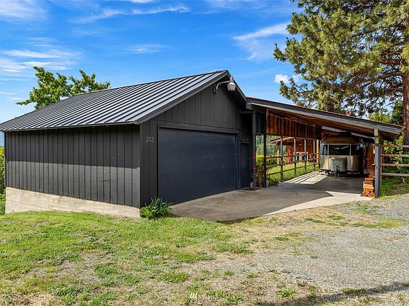 Two car detached garage and attached carport are accessed from the alley.