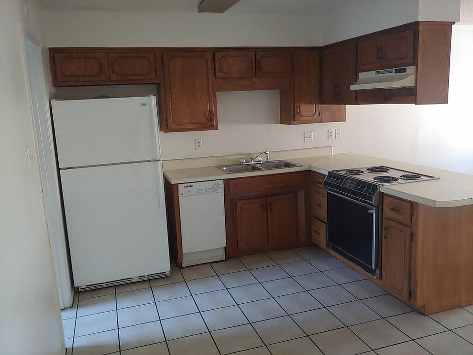 Kitchen with stove, dishwasher, and refrigerator with ice maker