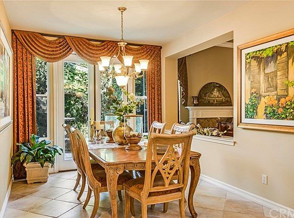 Intimate formal dining room opens to the formal living room for a peek at the fireplace.