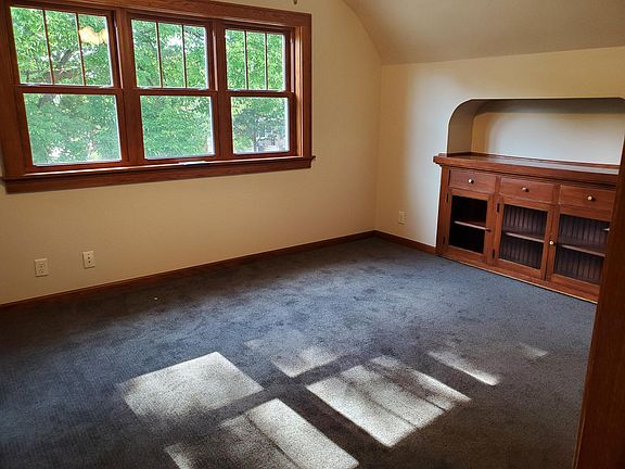 newly remodeled living room with original built in china cabinet