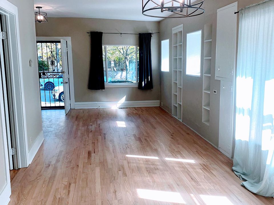 Large open L shaped dining/living/study areas flooded with natural sunlight.