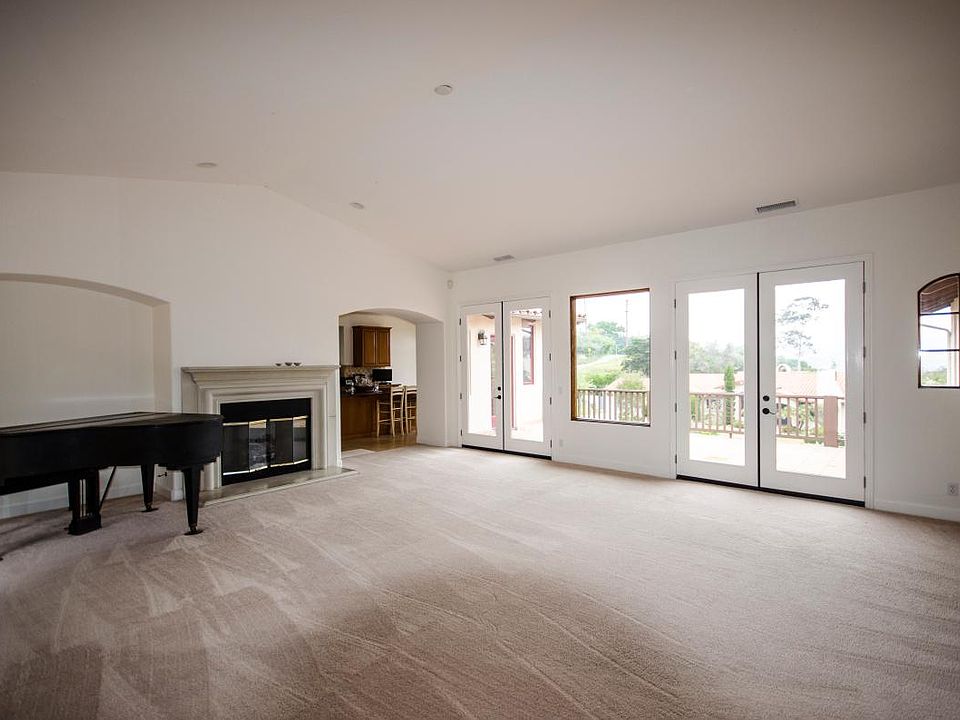 Large, high cathedral ceilinged living room has double frenc