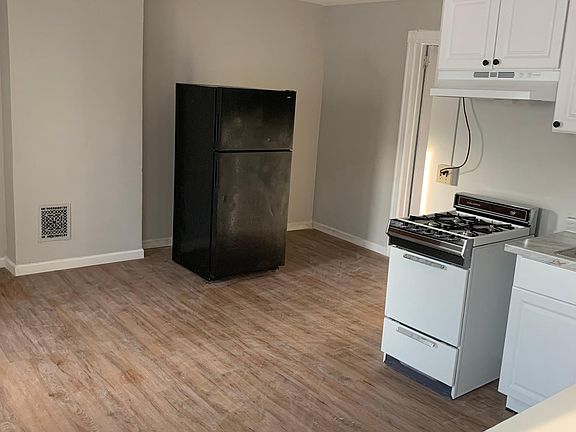 Open kitchen/living/dining space including a new gas stove. Fridge included