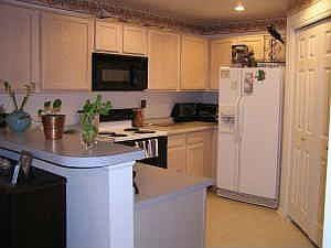 Kitchen w/ Util Rm and bar to Dining area