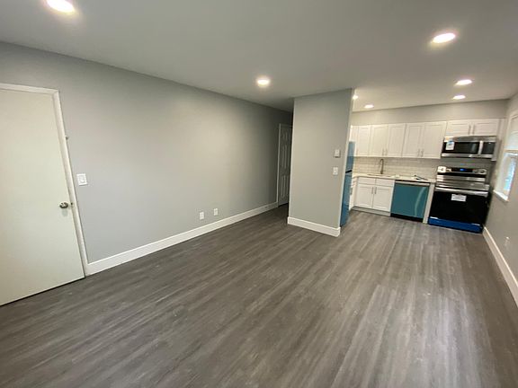 Living area with plenty of windows and new flooring