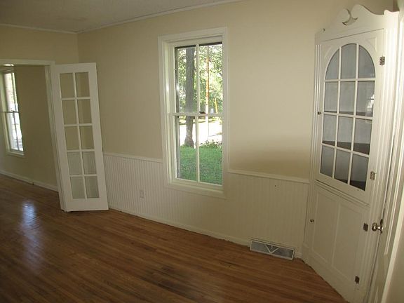 Formal dining room features built ins and French doors