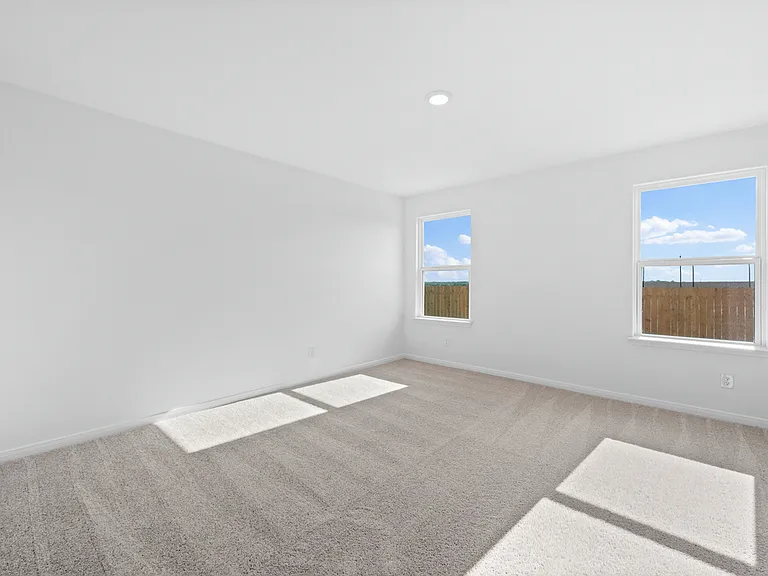 Master bedroom with two windows.