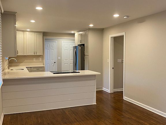 Open floor plan with recessed lighting and natural hardwood flooring.