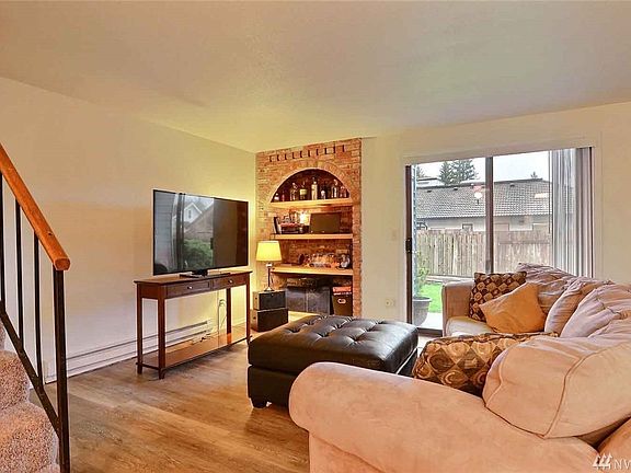 Living room with new laminate flooring, leading out to private patio.