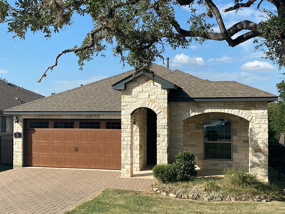All stone and stucco home with covered front porch