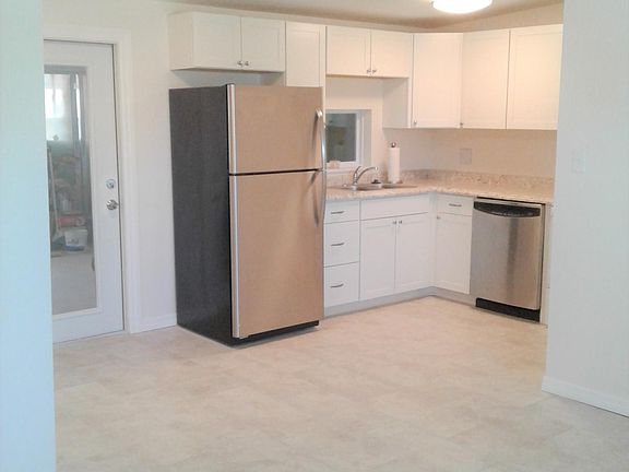 KITCHEN and DINING rooms -- view from living room. Door enters to covered patio.