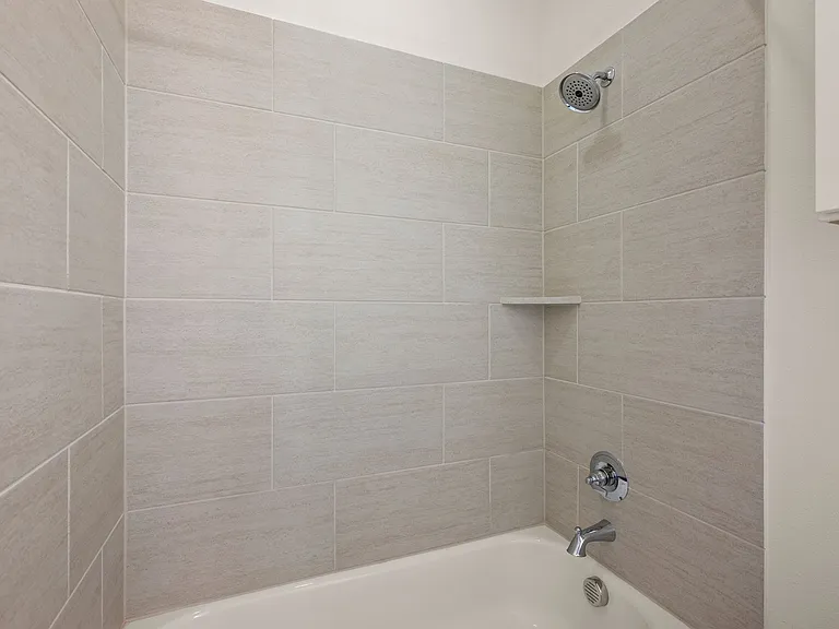 Bedroom #2 en suite full bathroom with shower and tub