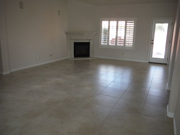 Living room with shutters & fireplace