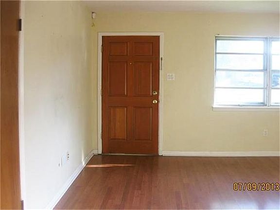 Entry and Living room, has laminate floors.