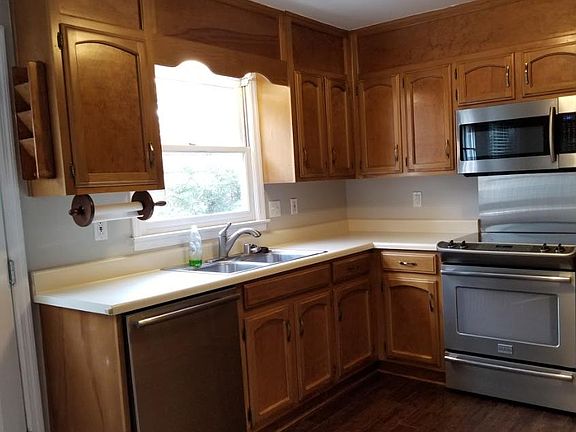Kitchen: double stainless steel sink with garbage disposal, dishwasher, range, microwave and refrigerator.