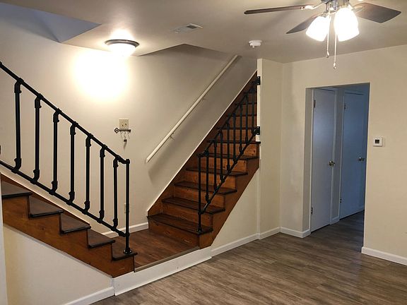 This shows the living room and wood stairs. Interior paint is freshly touched up for you!